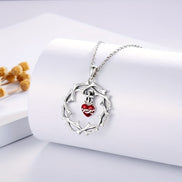 A red heart-shaped cross heart necklace with a chain