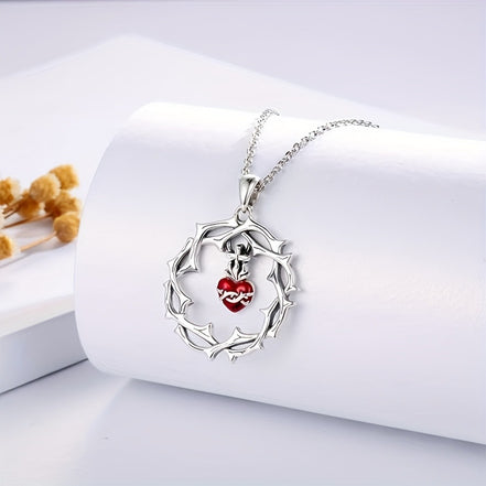 A red heart-shaped cross heart necklace with a chain