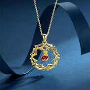 A red heart-shaped cross heart necklace with a chain