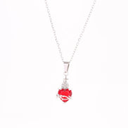 A red heart-shaped cross heart necklace with a chain