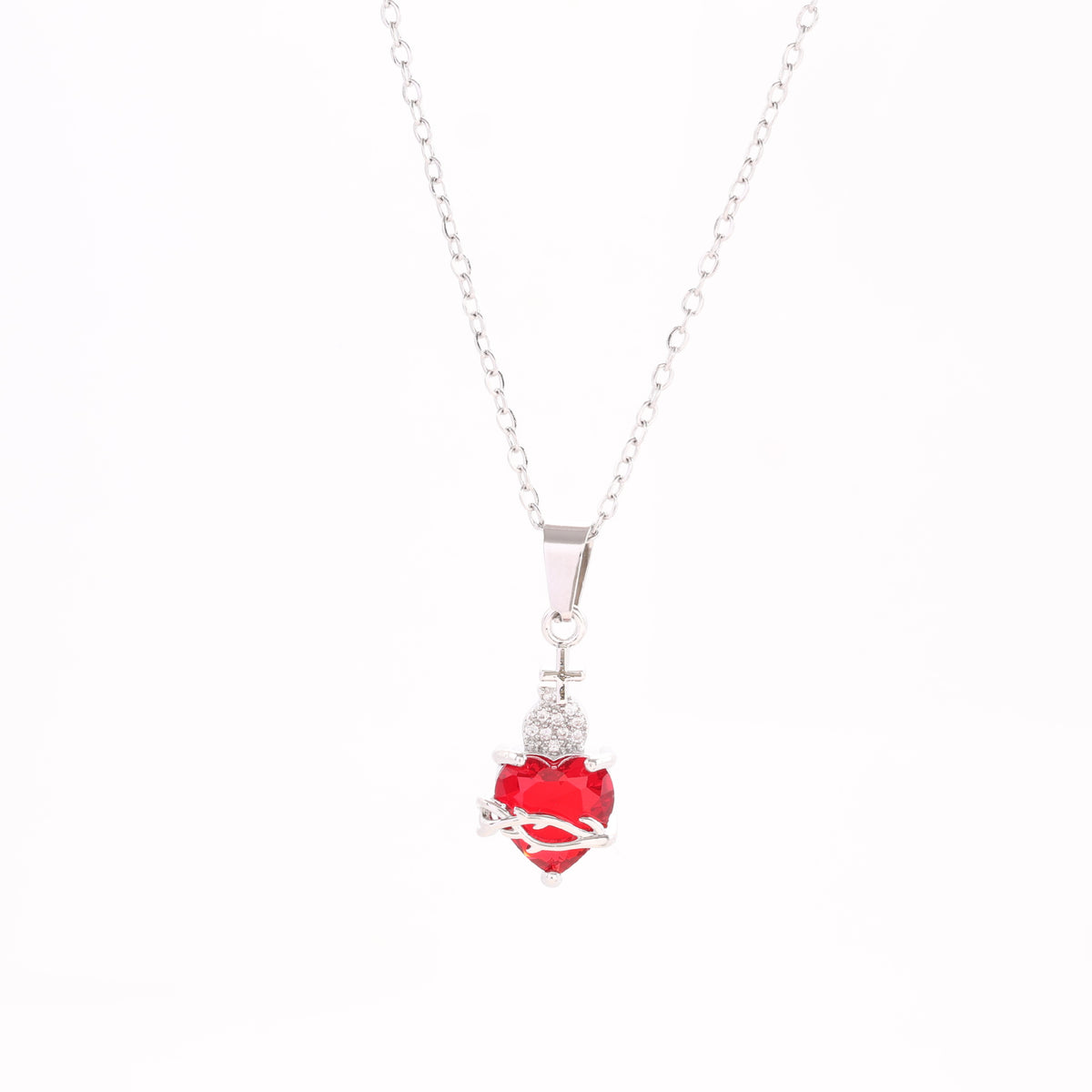 A red heart-shaped cross heart necklace with a chain