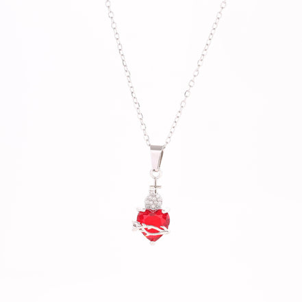 A red heart-shaped cross heart necklace with a chain