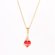 A red heart-shaped cross heart necklace with a chain