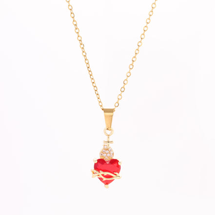 A red heart-shaped cross heart necklace with a chain