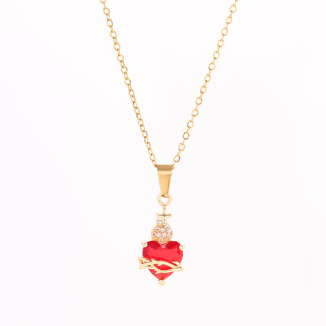 A red heart-shaped cross heart necklace with a chain