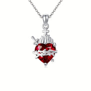 A red heart-shaped cross heart necklace with a chain