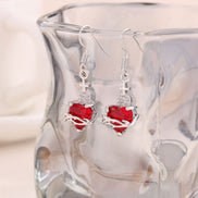 A red heart-shaped cross heart necklace with a chain