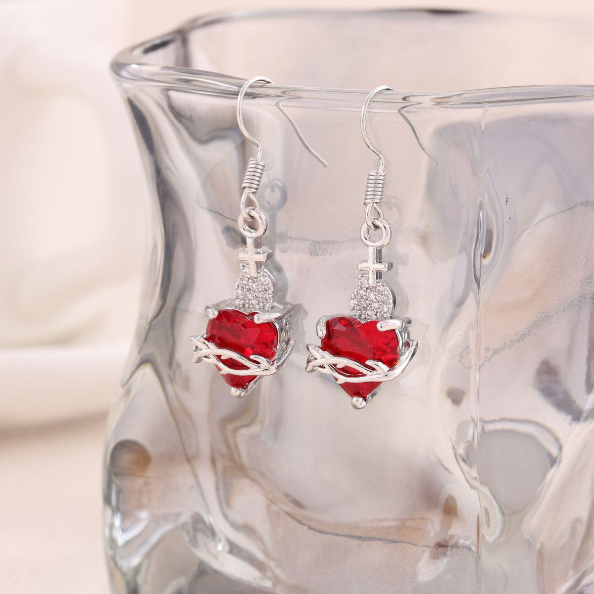 A red heart-shaped cross heart necklace with a chain