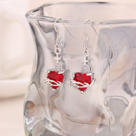 A red heart-shaped cross heart necklace with a chain